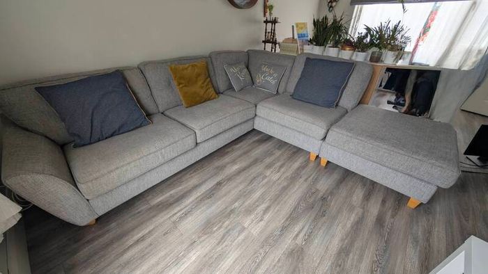 Gray fabric corner chase sofa with footstool