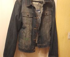 ED Hardy Denim Jacket.  More of a black/grey colour.  Fitted jacket.  Sleeves are long.  The decoration on the back is typical Ed Hardy
