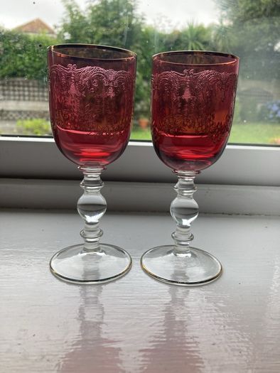 Pair of cranberry glass gold etched antique wine glasses