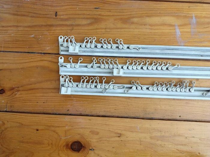 Three white plastic curtain rails