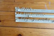 Three white plastic curtain rails