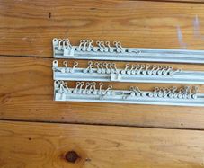 Three white plastic curtain rails