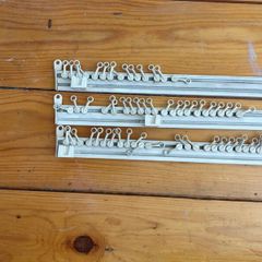 Three white plastic curtain rails