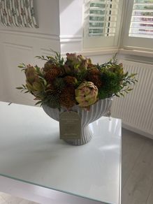 Autumnal faux flower display in ceramic vase