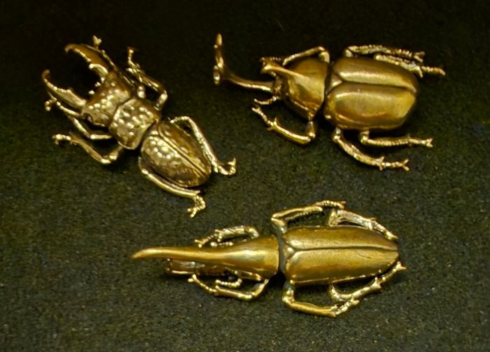 3 brass beetles.