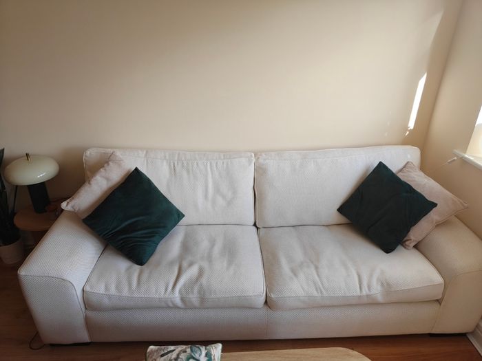 Cream fabric three-seater sofa