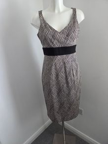 Never Worn. Size 12 Coast cream and black v-neck dress with gorgeous twist back detail.