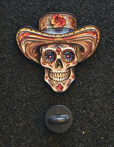 Skull, pin back badge.