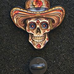 Skull, pin back badge.