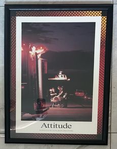 Framed Motivational Attitude Photo showing ambulance crew working on patient on trolley with ambulance in foreground.