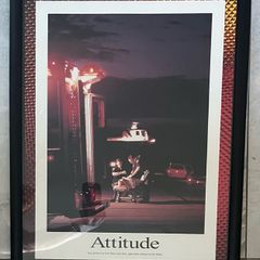 Framed Motivational Attitude Photo showing ambulance crew working on patient on trolley with ambulance in foreground.