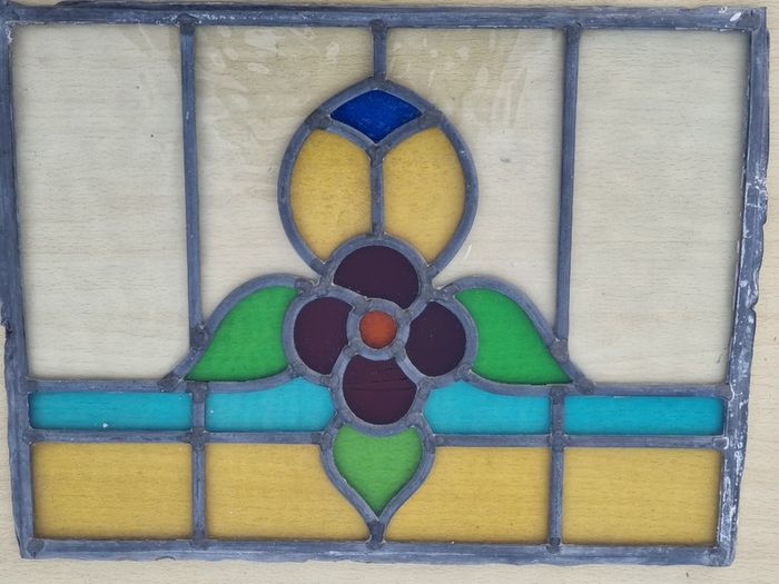 Antique leaded stained-glass panel in the Art Nouveau style.