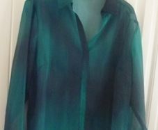 Green sheer blouse with tie-cuff detail
