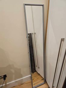 Freestanding metal mirror