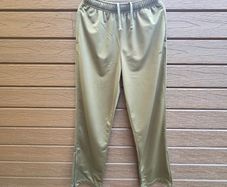 New FILA olive green athletic track pants with an elastic drawstring waistband and zippered ankle hems.