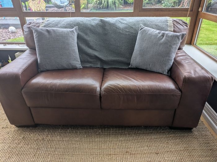 Brown faux-leather two-seater sofa