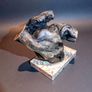Free form bog oak statue on red marble Image 2