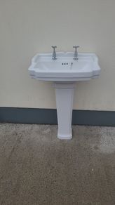 Bathroom sink with pedestal, taps and trap
