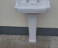 Bathroom sink with pedestal, taps and trap