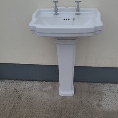 Bathroom sink with pedestal, taps and trap