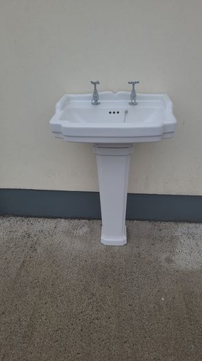 Bathroom sink with pedestal, taps and trap