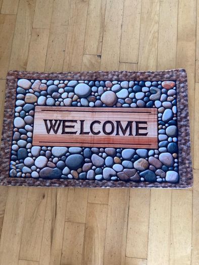 Mat with Welcome on it . Stones design on it. 76 x 50cm