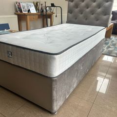 Two single beds with mattresses and headboards