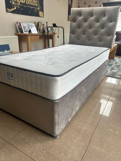 Two single beds with mattresses and headboards