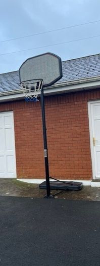 Portable Basketball Stand- Adjustable. stored in garage when not in use. In Very Good Condition.