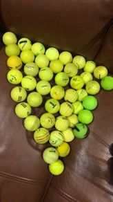 Bucket of yellow golf balls
