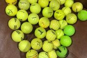 Bucket of yellow golf balls