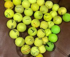 Bucket of yellow golf balls