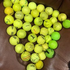 Bucket of yellow golf balls