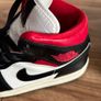 Nike Air Jordan 1 Mid trainers in the classic black, white and red colourway Image 10