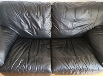 Black leather two-seater sofa