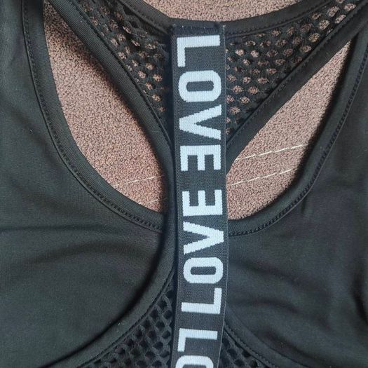 Black sports bra with white lettering, size 10