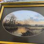 VINTAGE Framed landscape print featuring an oval matte aperture with a golden sunset or sunrise over a river, bare trees, and two birds flying in the sky. Image 8