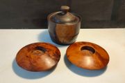 A pair of Burr Walnut tea light holders and burr lidded container