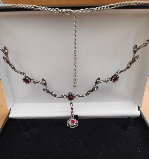 Silver tone floral necklace with red gemstone style accents