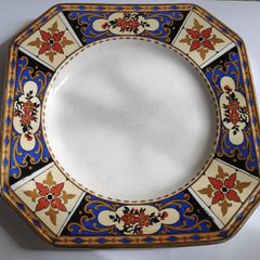 Antique small octagonal plate with floral pattern in blue, red and ochre tones