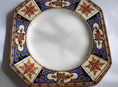 Antique small octagonal plate with floral pattern in blue, red and ochre tones