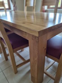 Solid oak dining table + 6 solid oak chairs .