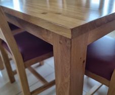 Solid oak dining table + 6 solid oak chairs .