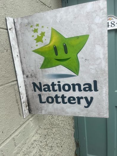 Double sided national lottery wall sign.