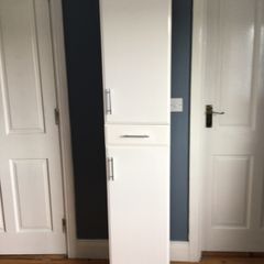 Tall white storage unit with drawer