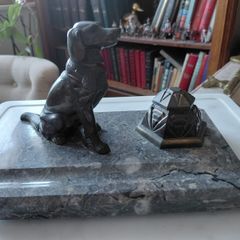 Antique desk inkwell with a seated dog on marble stand