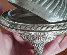 A vintage silver-plated butter dish or caviar bowl with a three-legged lid.