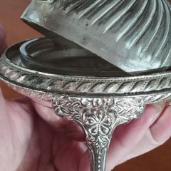 A vintage silver-plated butter dish or caviar bowl with a three-legged lid.