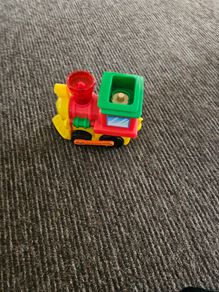 Toy train set with track and trailer