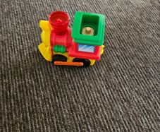 Toy train set with track and trailer